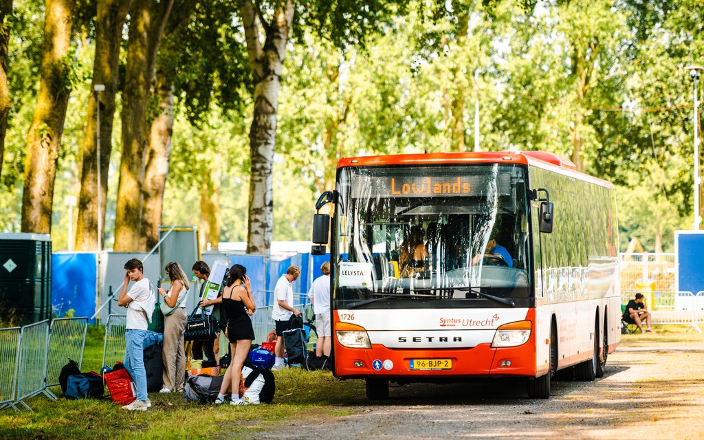 Bezoekers stappen uit pendelbus Bezoekers stappen uit pendelbus