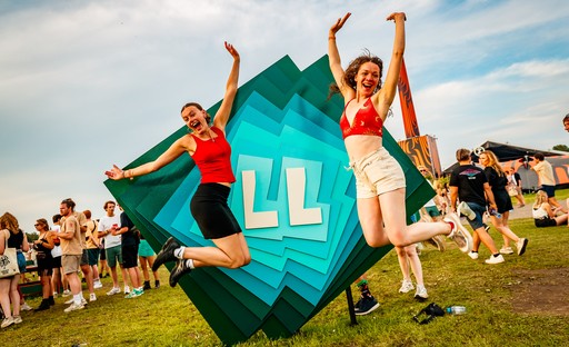 Twee enthousiaste bezoeksters voor het Lowlands logo Twee enthousiaste bezoeksters voor het Lowlands logo
